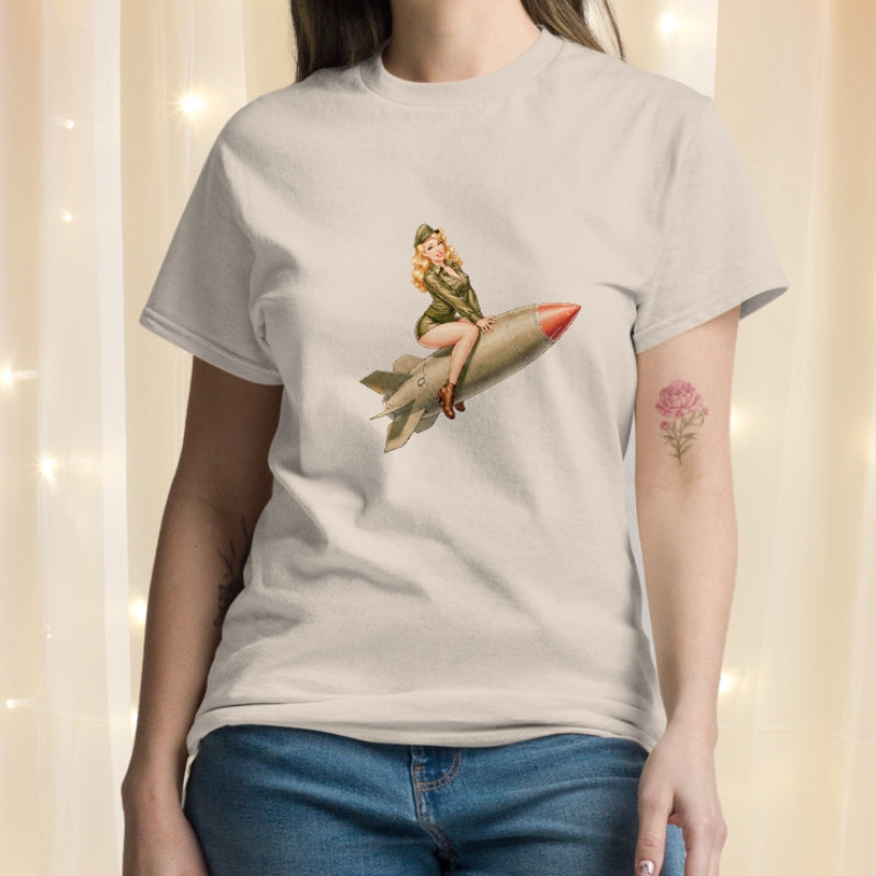 Person wearing a t-shirt with a graphic of a woman on a rocket.