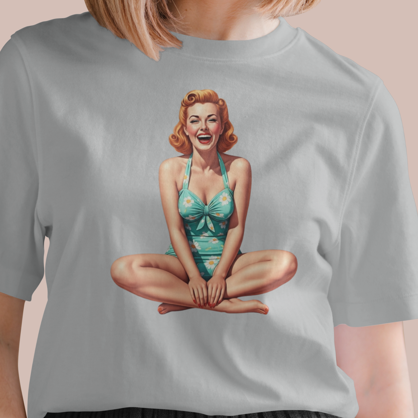 Gray t-shirt with a vintage-style graphic of a woman in a swimsuit on a beige background