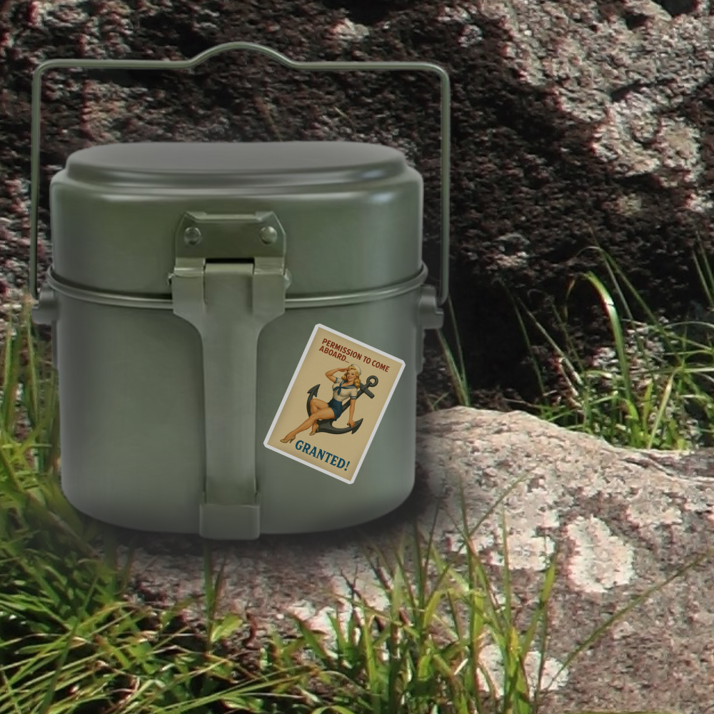 Green metal lunch box with a sticker on a rock and grass background