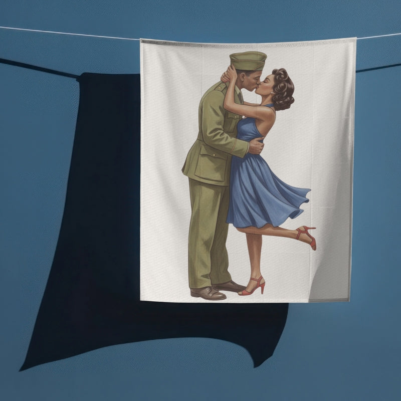 Towel with a printed design of a couple embracing, hanging on a line against a blue background.