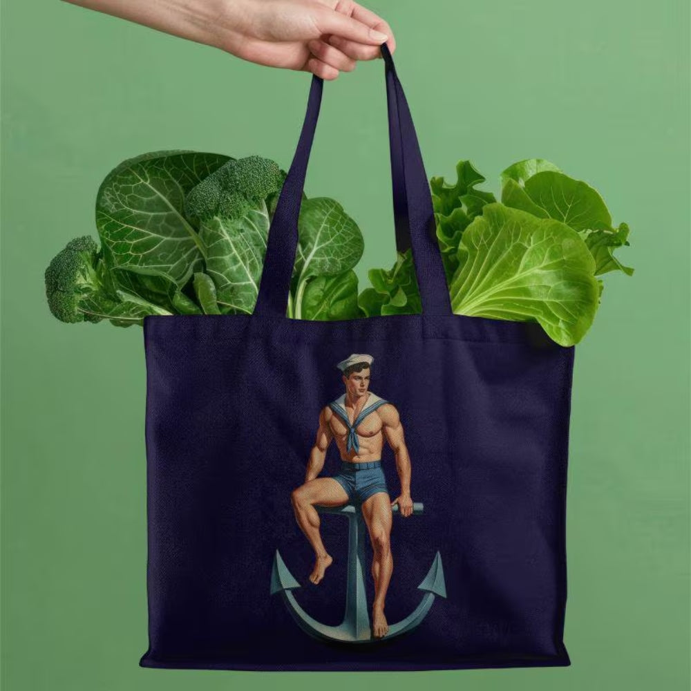 Navy tote bag with a sailor design filled with vegetables on a green background