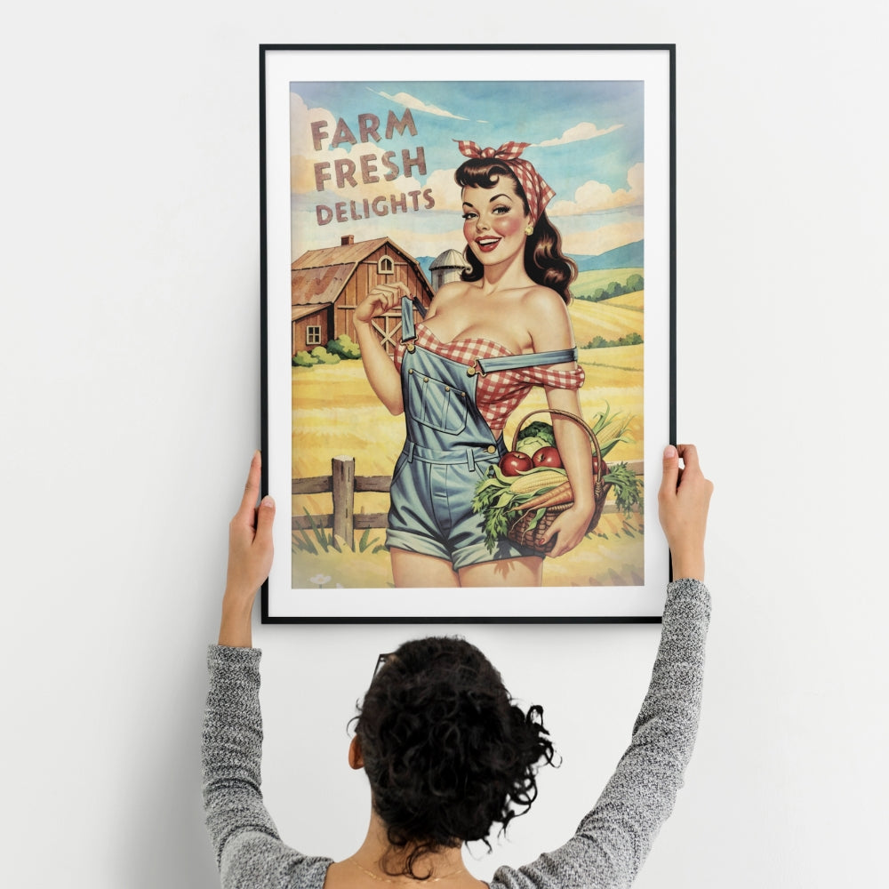 Person hanging a framed vintage-style poster of a woman on a farm with 'Farm Fresh Delights' text.