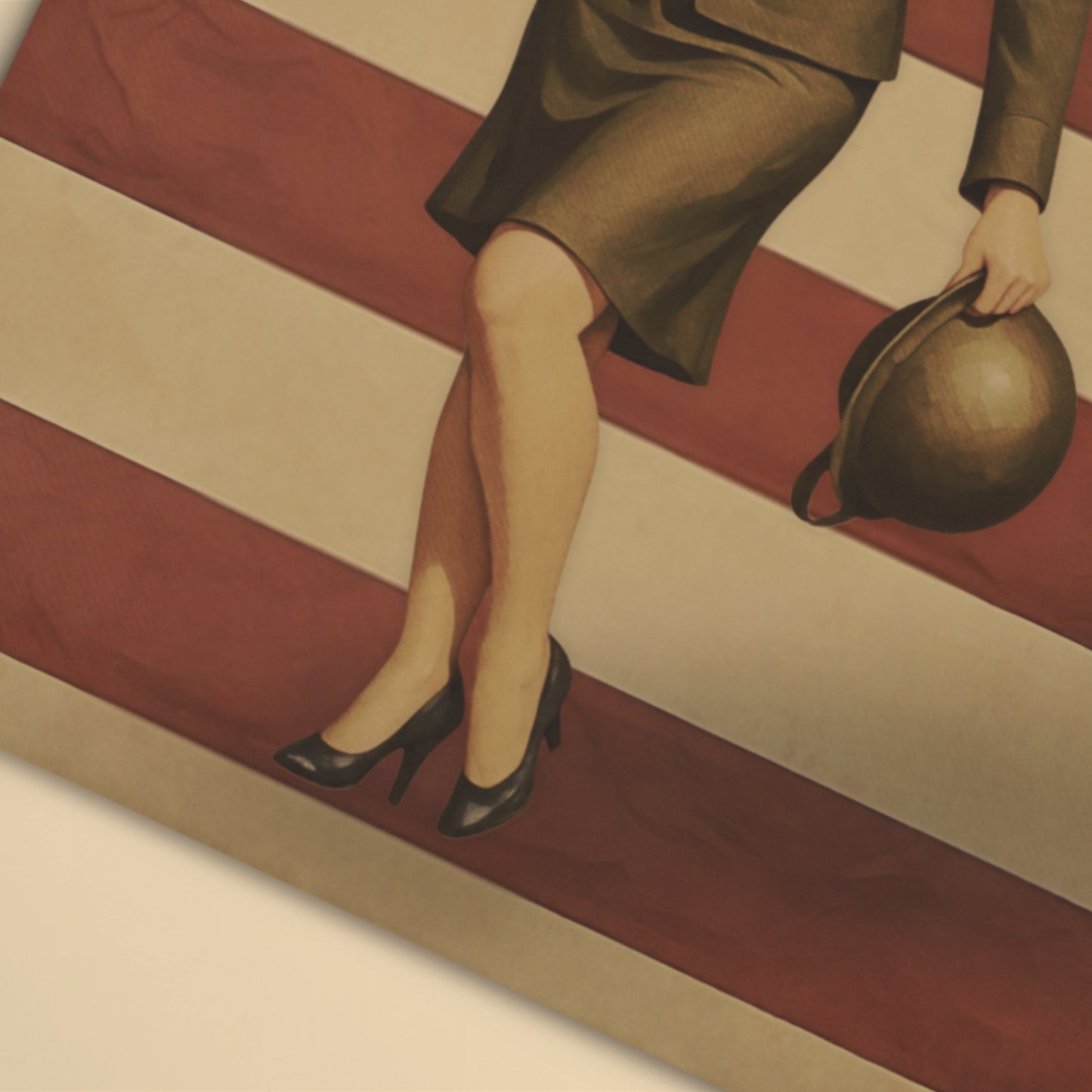 Woman's legs in high heels and a skirt, holding a handbag on a striped floor.