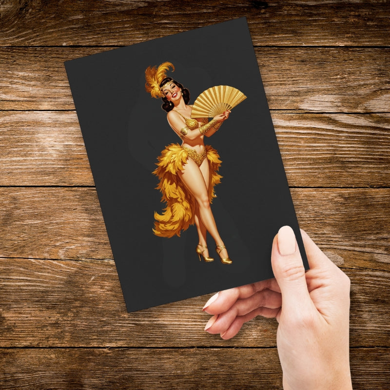 Hand holding a card with a vintage-style illustration of a dancer on a wooden surface