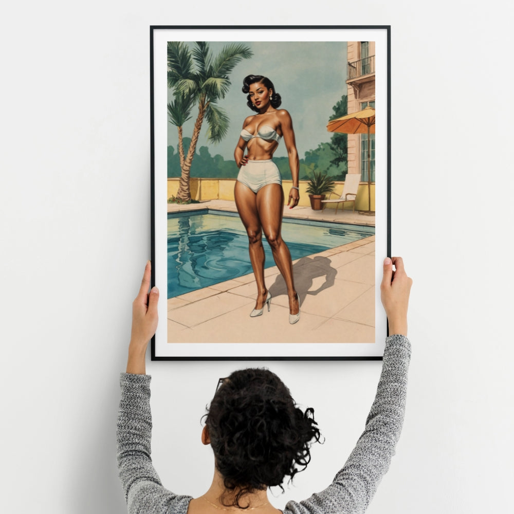 Person holding a framed artwork of a 1950s black woman in a swimsuit by a pool.
