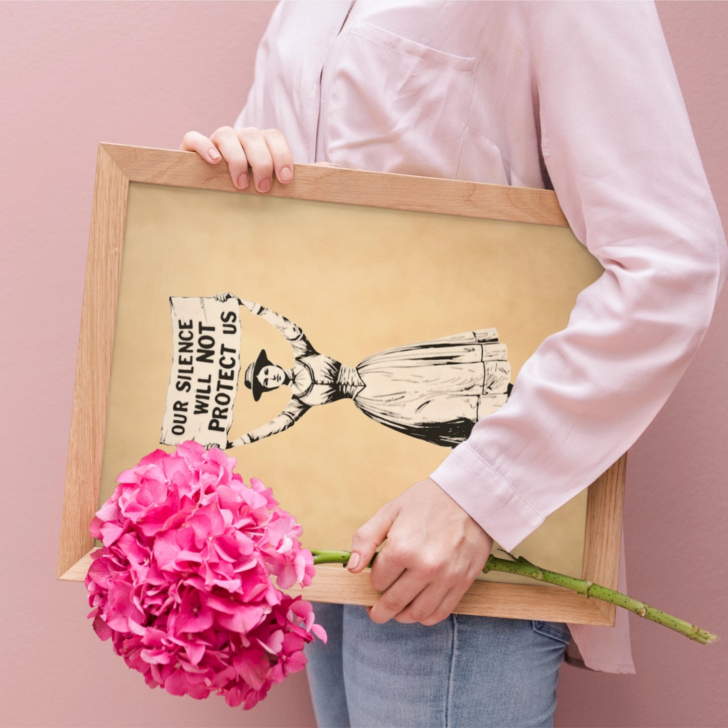 Person holding a framed artwork with a pink flower against a pink background