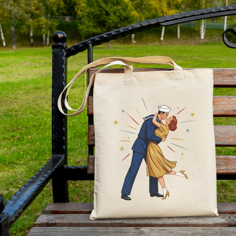 Tote bag with a design of a couple embracing, placed on a wooden bench outdoors.