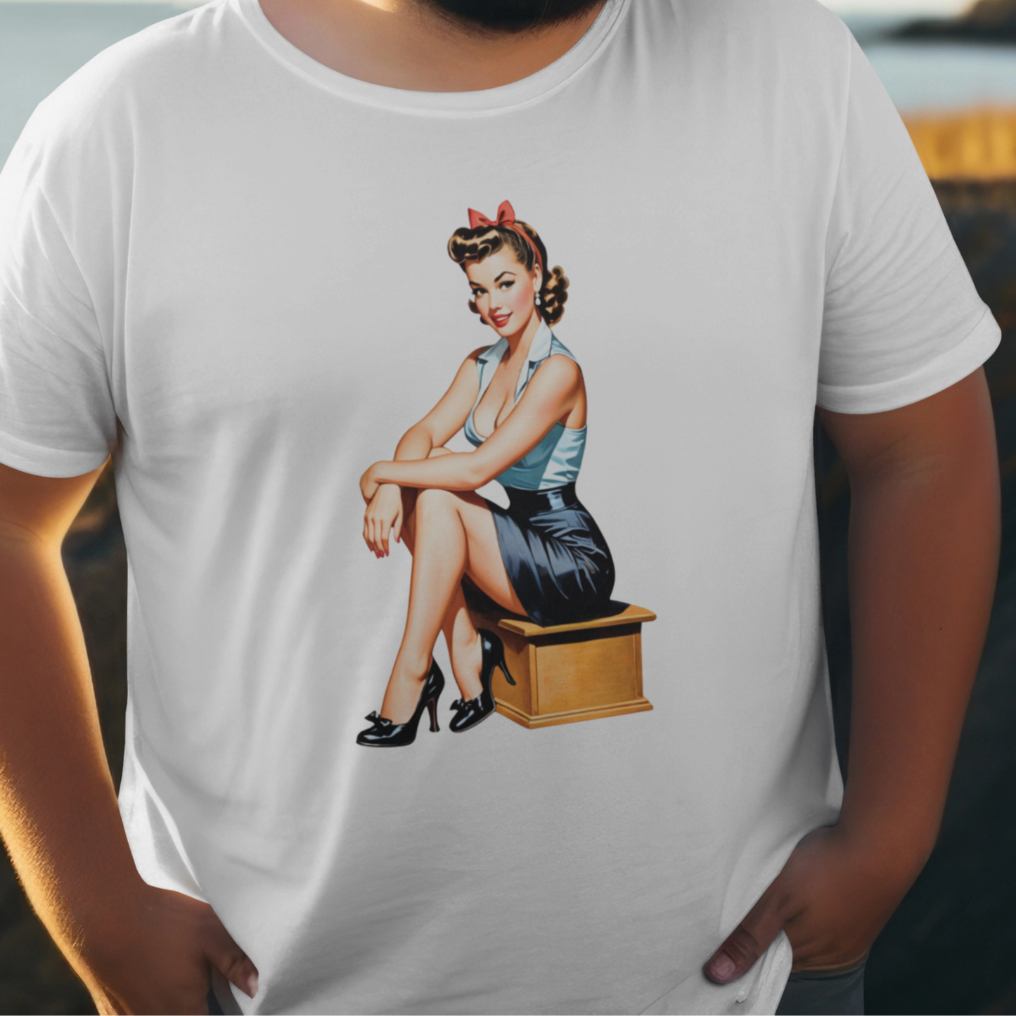 White t-shirt with a graphic of a woman sitting on a box, worn by a person.