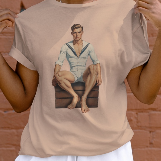 Person wearing a beige t-shirt with a graphic of a man in a sailor outfit.