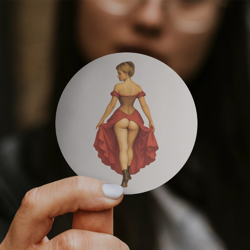 Hand holding a round card with an illustration of a woman in a red dress against a blurred background