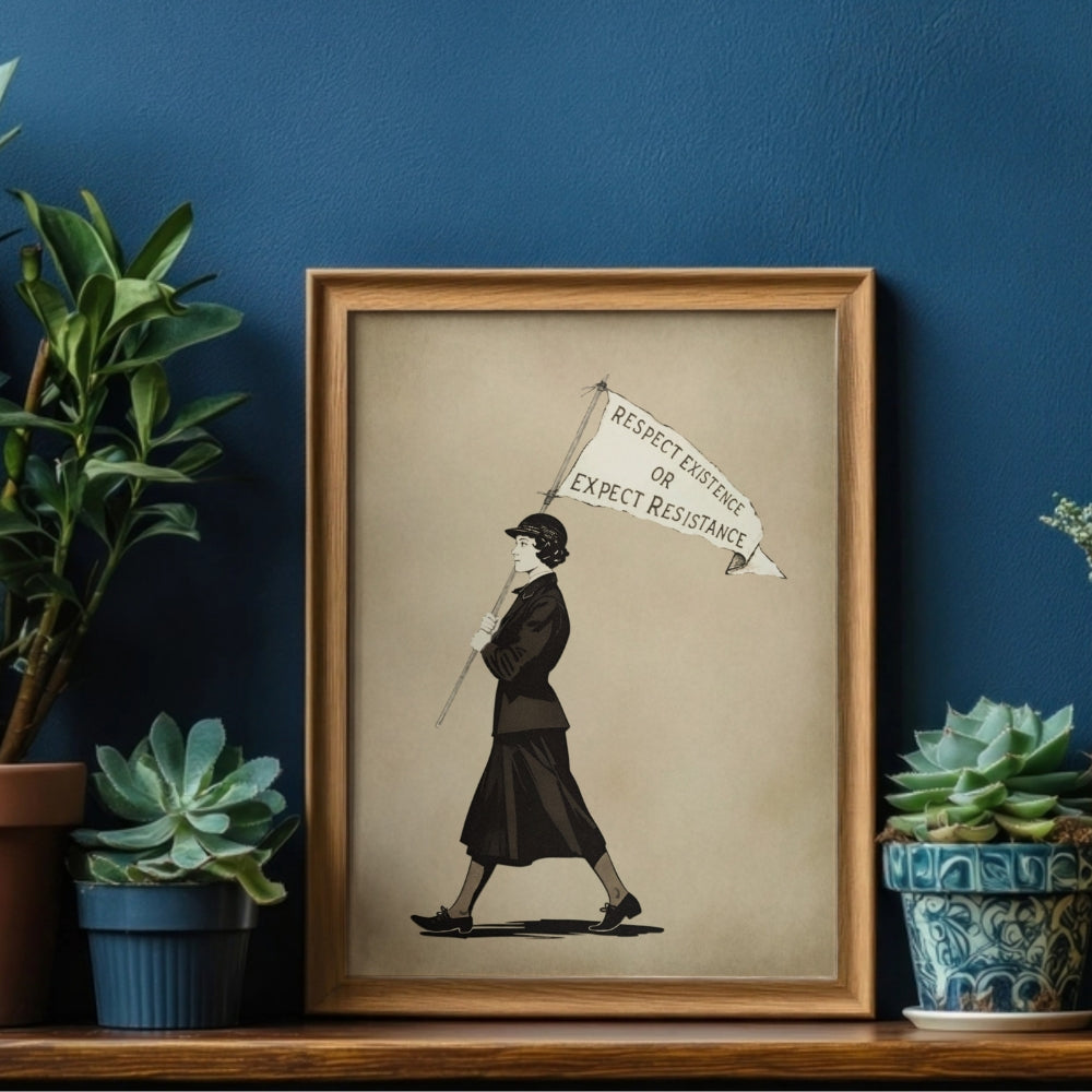Framed Respect Existence or Expect Resistance artwork of a vintage suffragist holding a flag with text, placed on a shelf against a blue wall with plants.