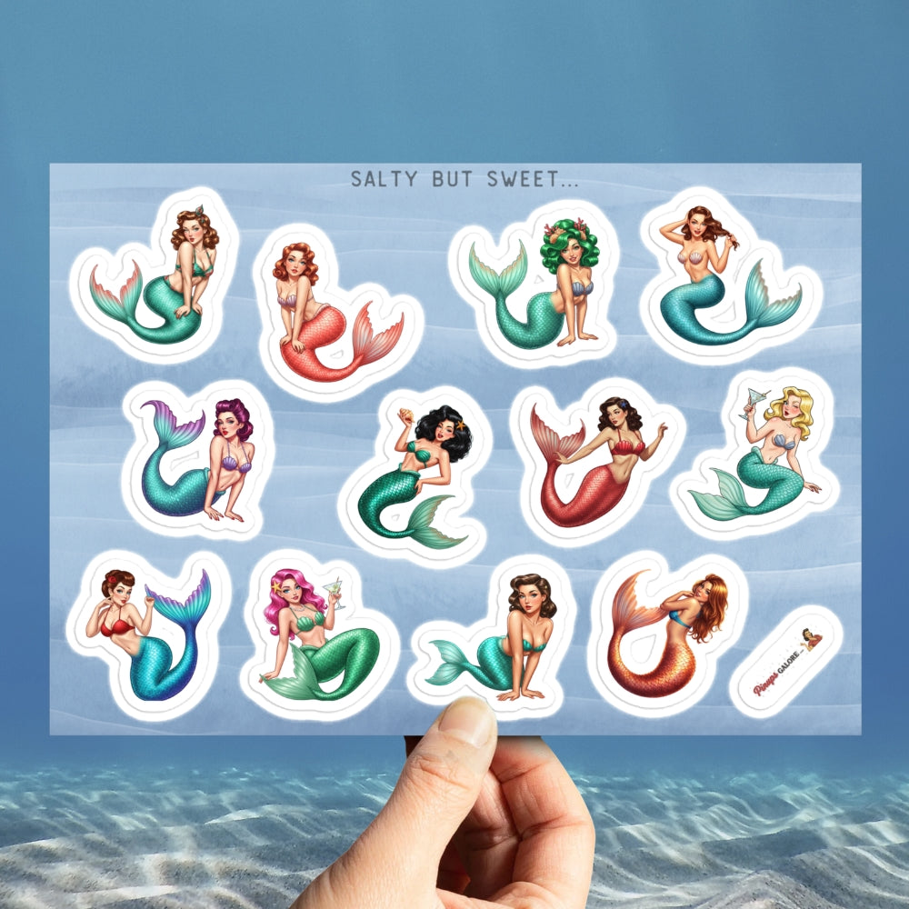Sheet of mermaid stickers held over a blue water background