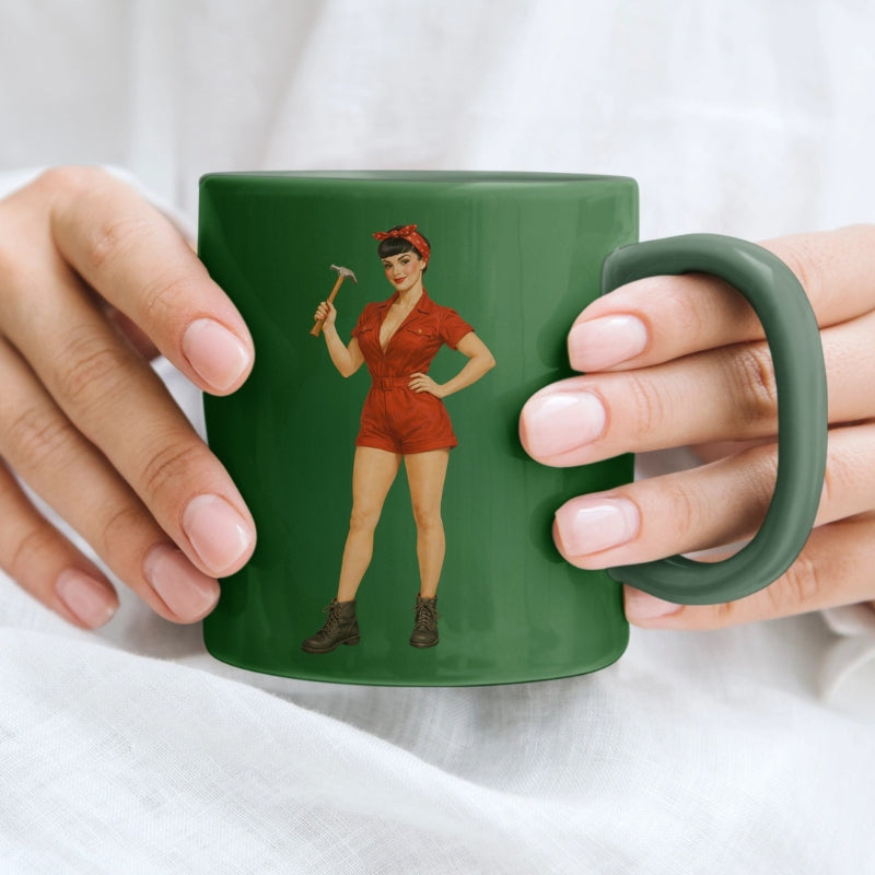 Green mug with a graphic of a woman holding a hammer, held by two hands.