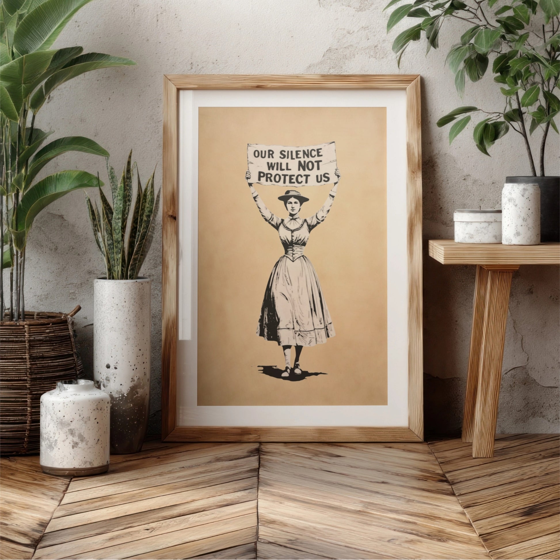 Framed artwork of a woman holding a sign with text in a home setting.