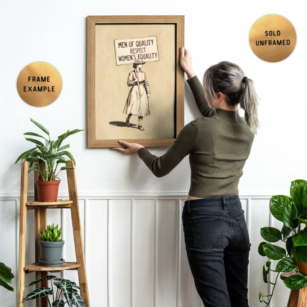 Woman hanging a framed artwork that says Men of Quality Respect Women's Equality on a wall with plants around