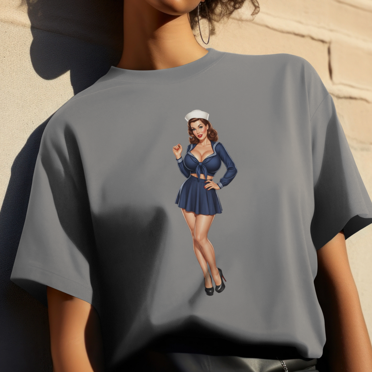 Gray t-shirt with a graphic of a woman in a blue outfit on a beige background