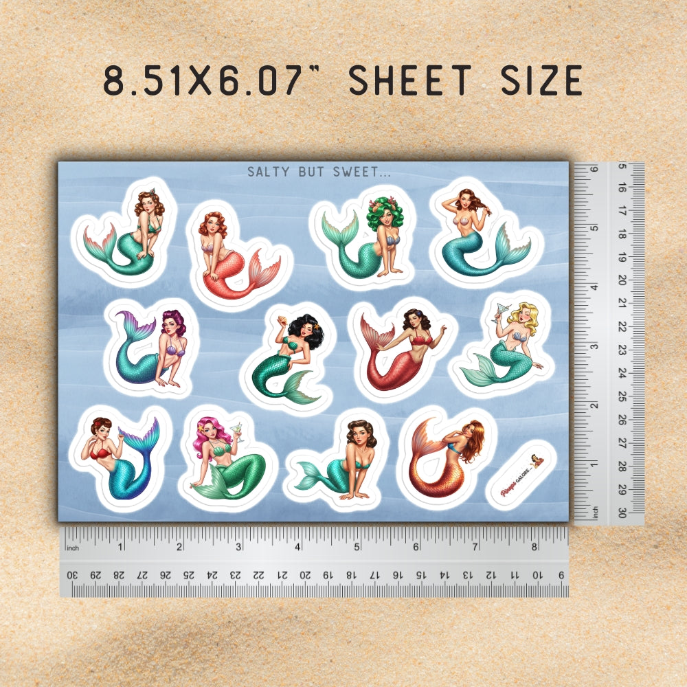Sheet of mermaid stickers with a ruler for scale on a wooden surface
