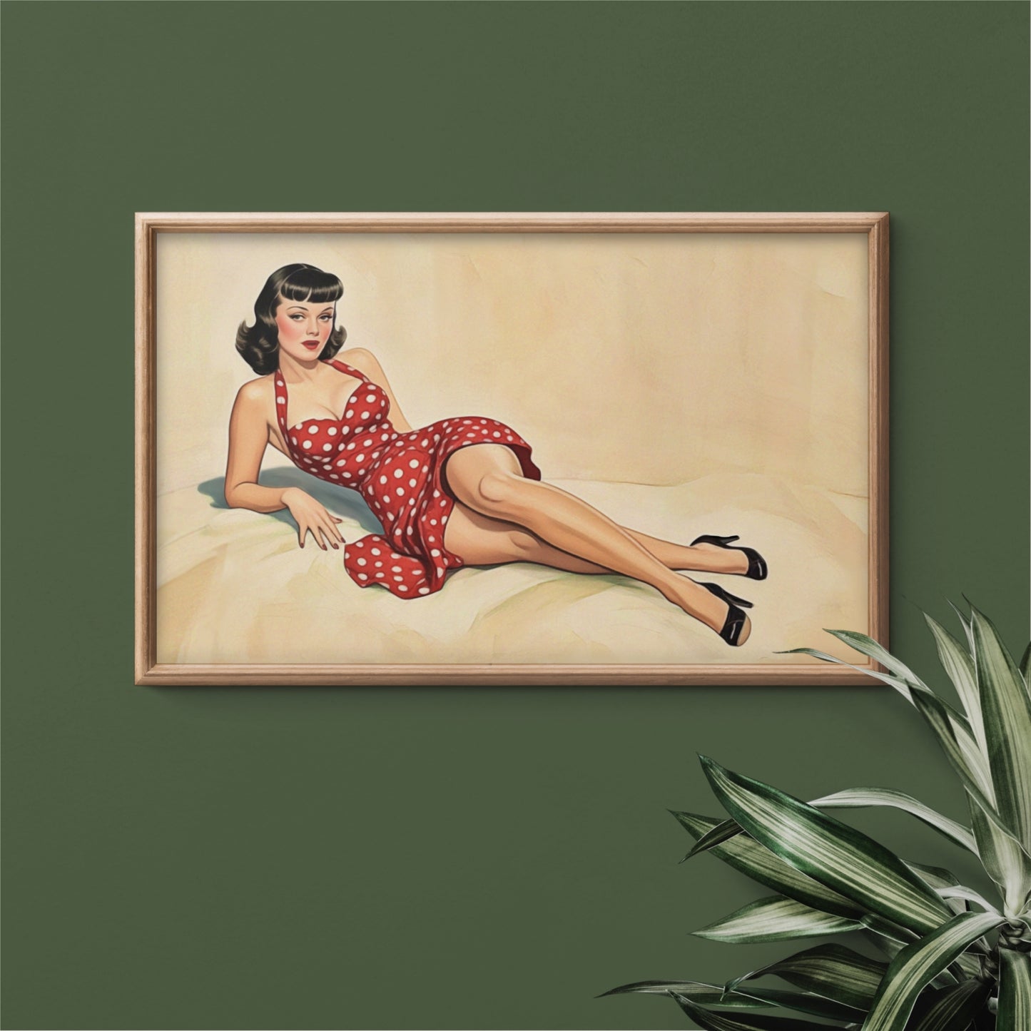 Framed artwork of a woman in a red polka dot dress on a green wall.