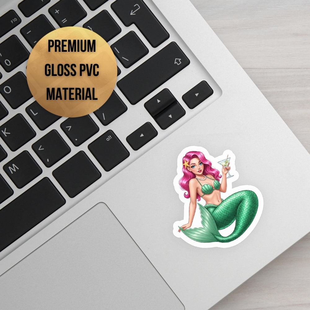 Mermaid sticker on a laptop keyboard with 'Premium Gloss PVC Material' label.