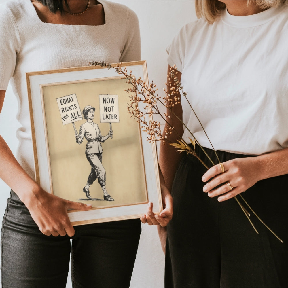 Two people holding a framed artwork with a woman holding signs advocating for equal rights.