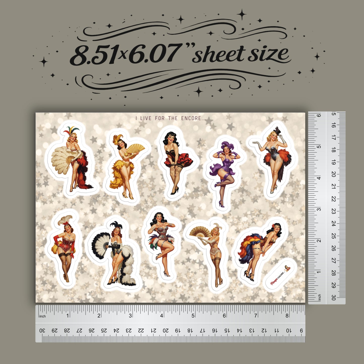 Sheet of stickers with illustrated characters on a beige background, accompanied by a ruler for scale.