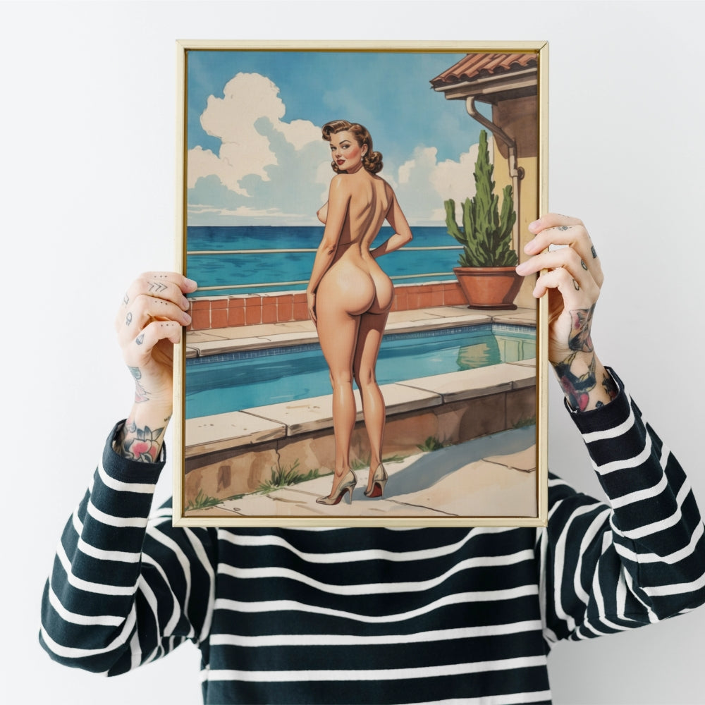 Person holding a framed artwork of a woman by a pool with ocean view.