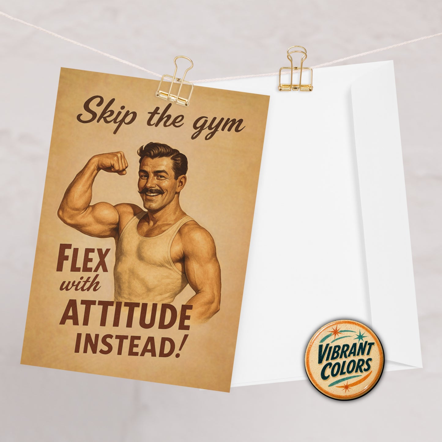 Poster greeting card with vintage-style illustration of a muscular man and motivational text, pinned to a whiteboard.