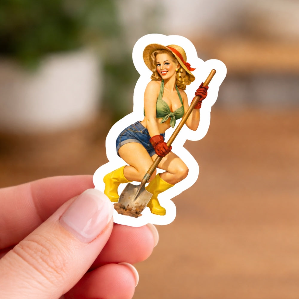 Sticker of a woman holding a shovel held by a hand against a blurred background