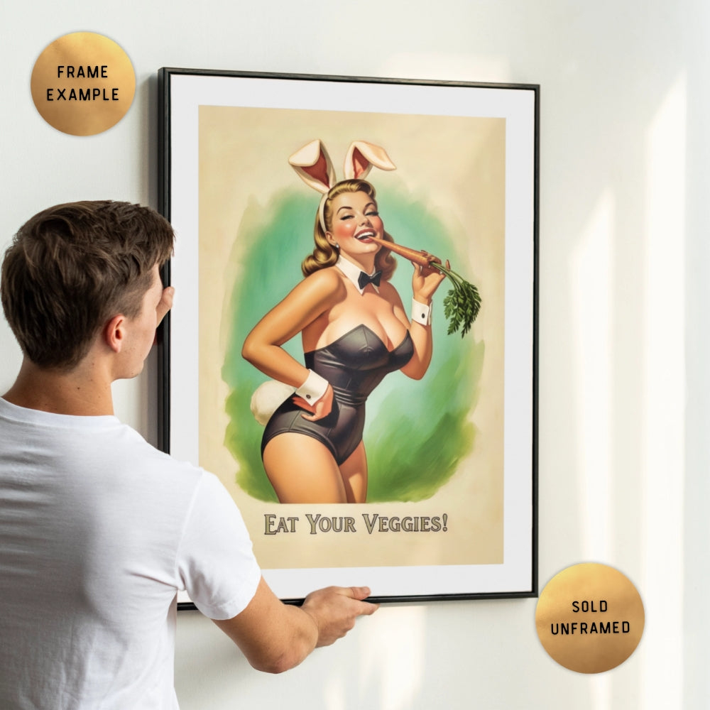 Person holding a framed poster of a woman in a swimsuit with bunny ears, holding a carrot with text 'Eat Your Veggies!'.