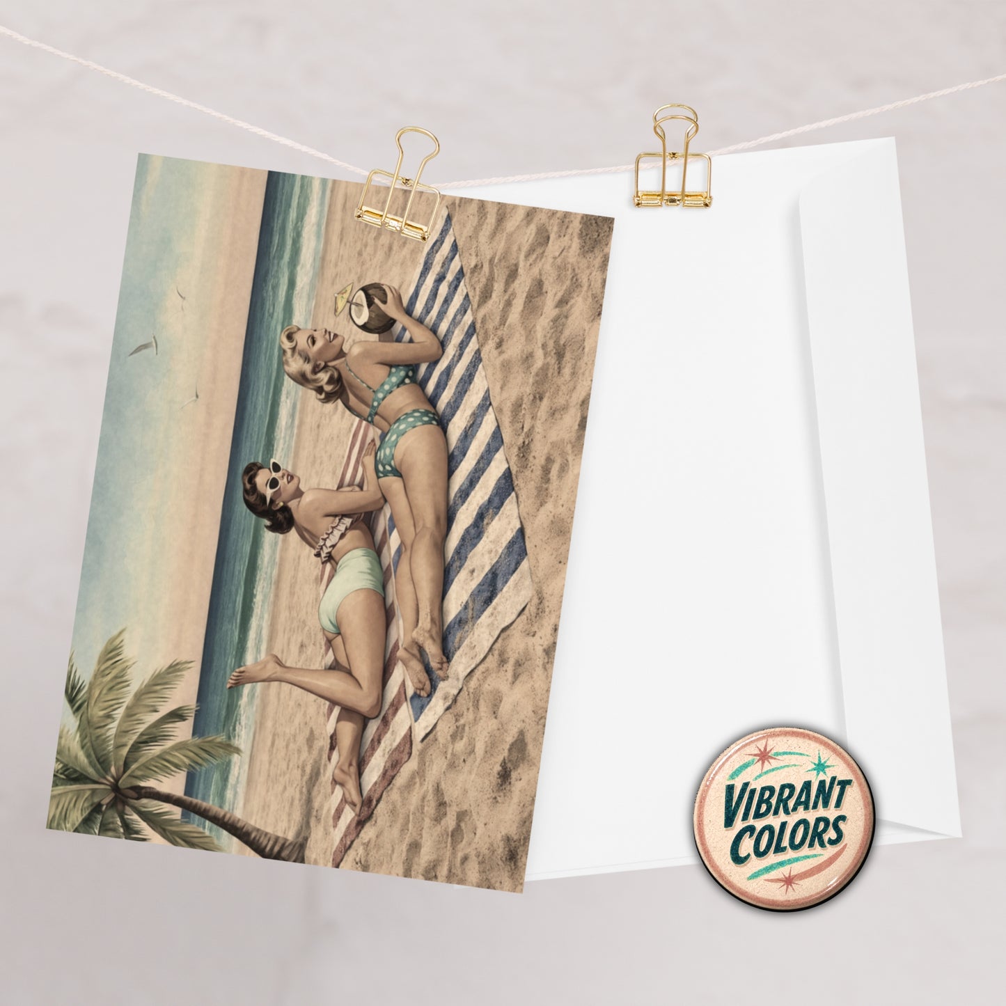 Vintage-style pinup card of two women in swimsuits on a beach with 'Vibrant Colors' logo.