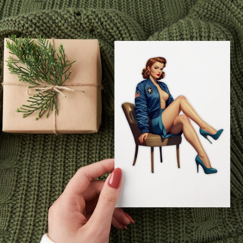 Gift wrapped in brown paper with greenery, held by a hand, next to a pin-up style illustration of a woman in a blue jacket.