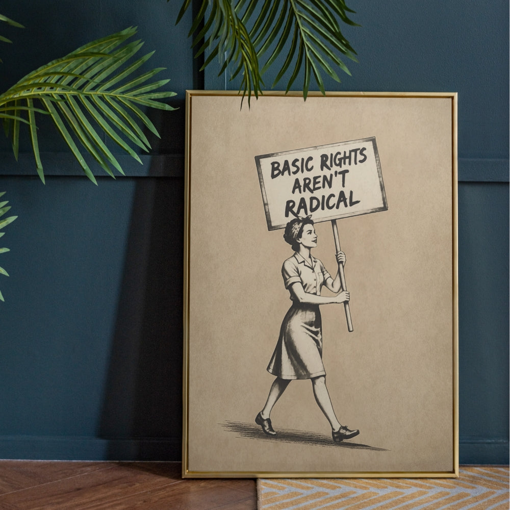 Framed artwork of a woman holding a sign with 'Basic Rights Aren't Radical' text against a dark blue wall.