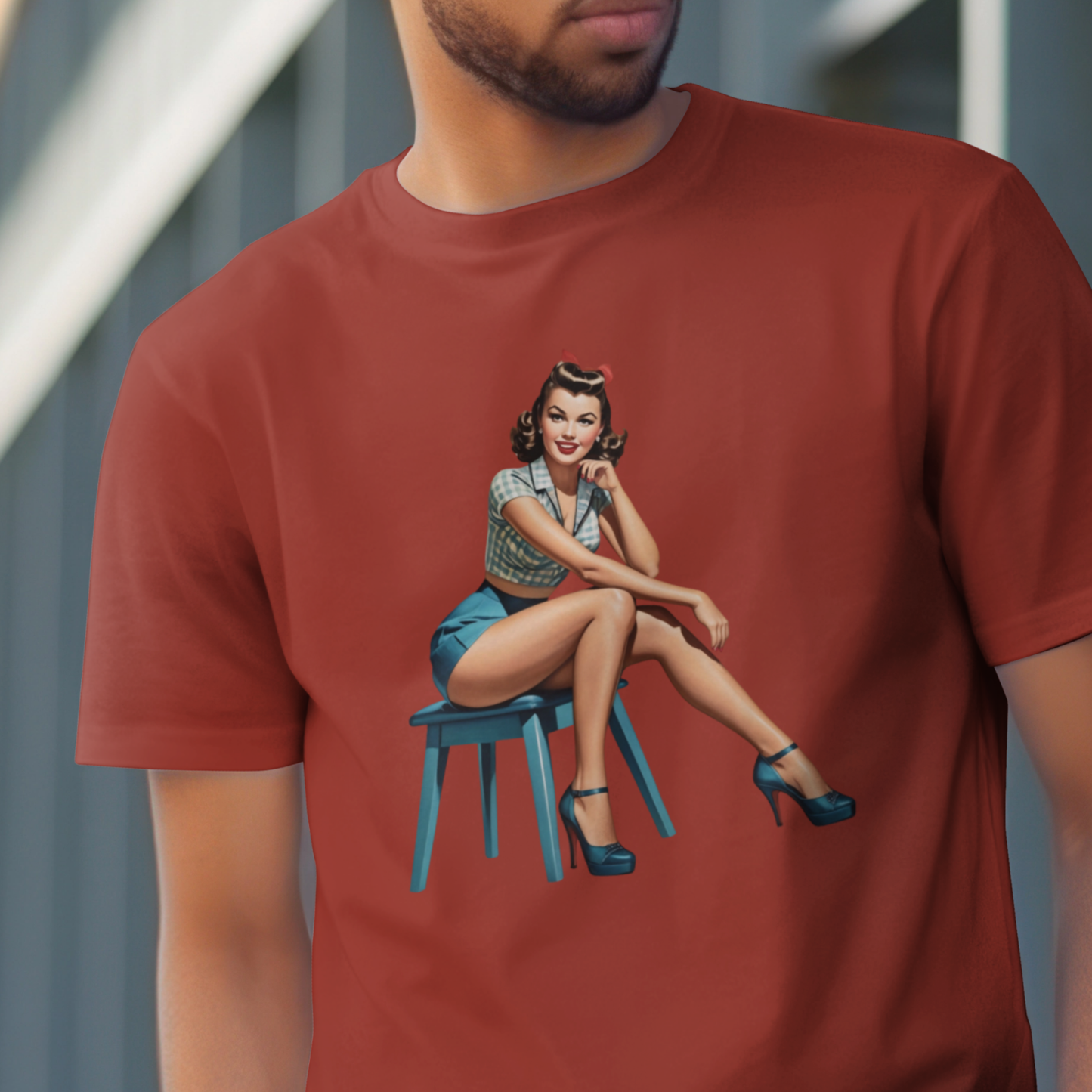 Red t-shirt with a graphic of a woman sitting on a chair on a blurred background
