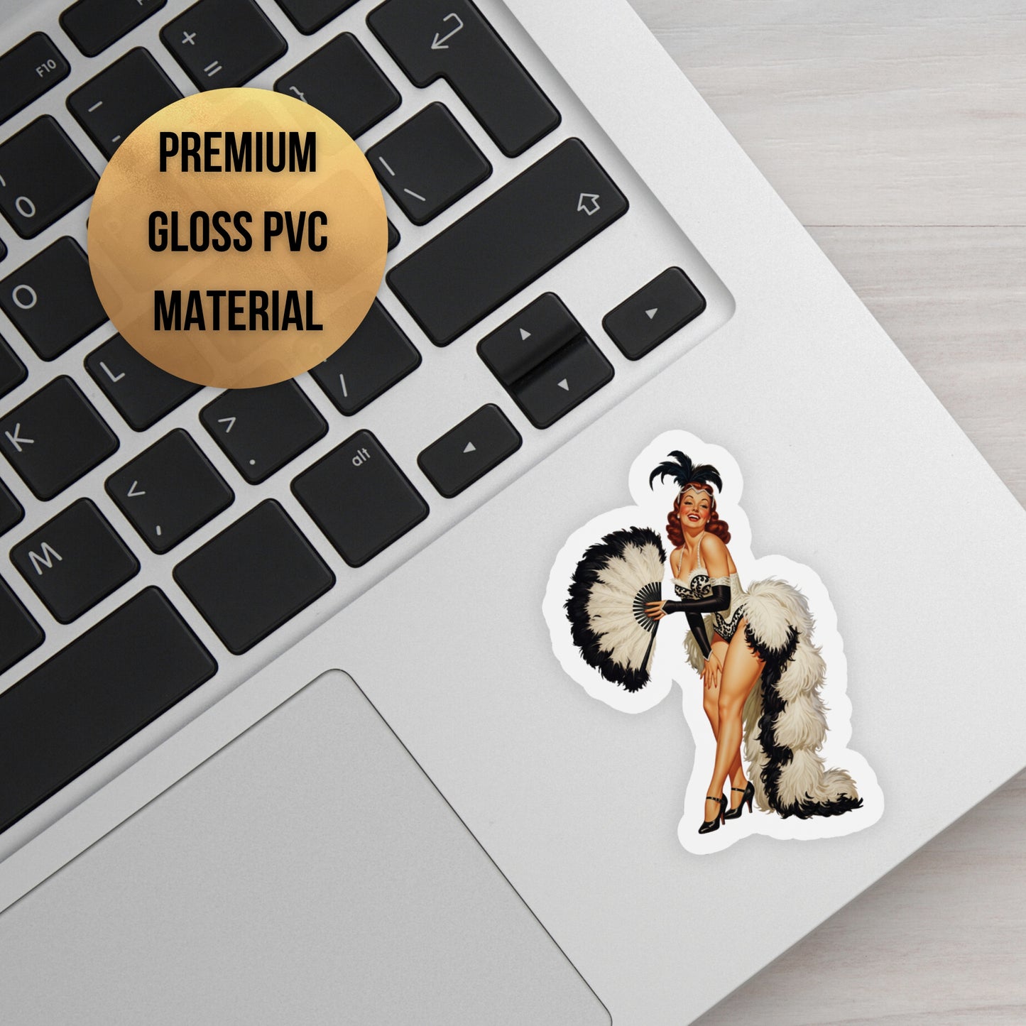 Sticker of a woman in a costume on a laptop keyboard with a label indicating premium gloss PVC material.