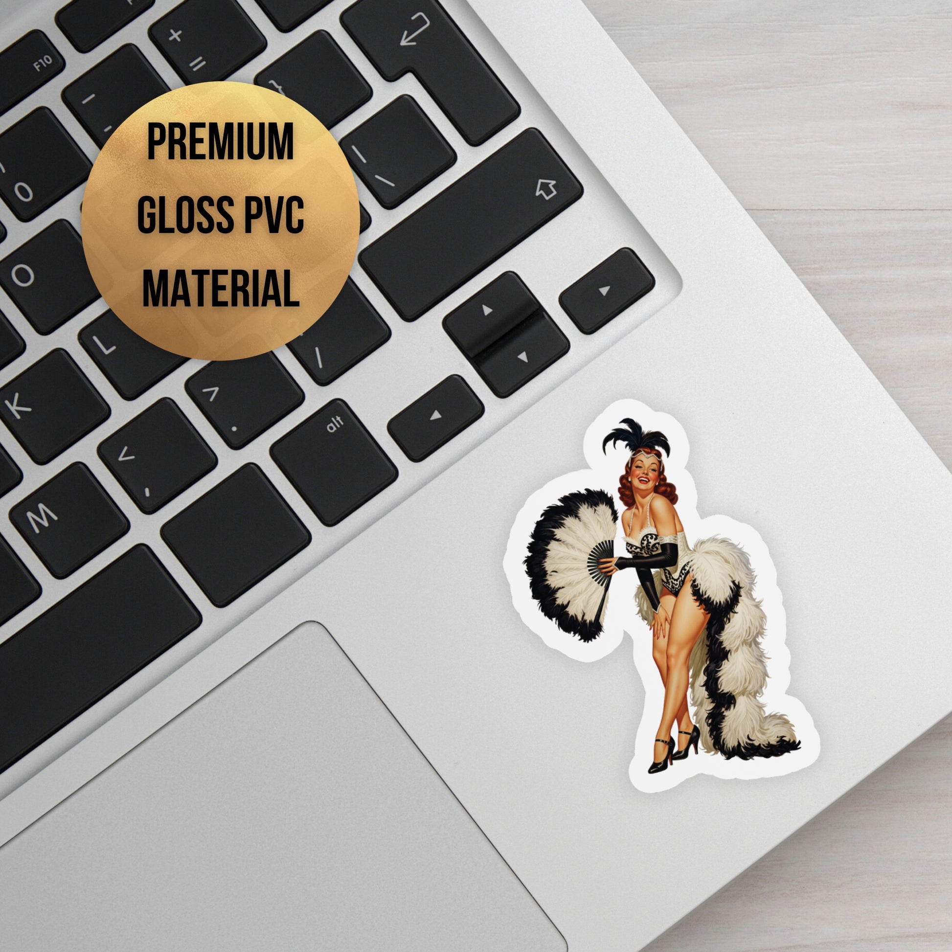 Sticker of a woman in a costume on a laptop keyboard with a label indicating premium gloss PVC material.