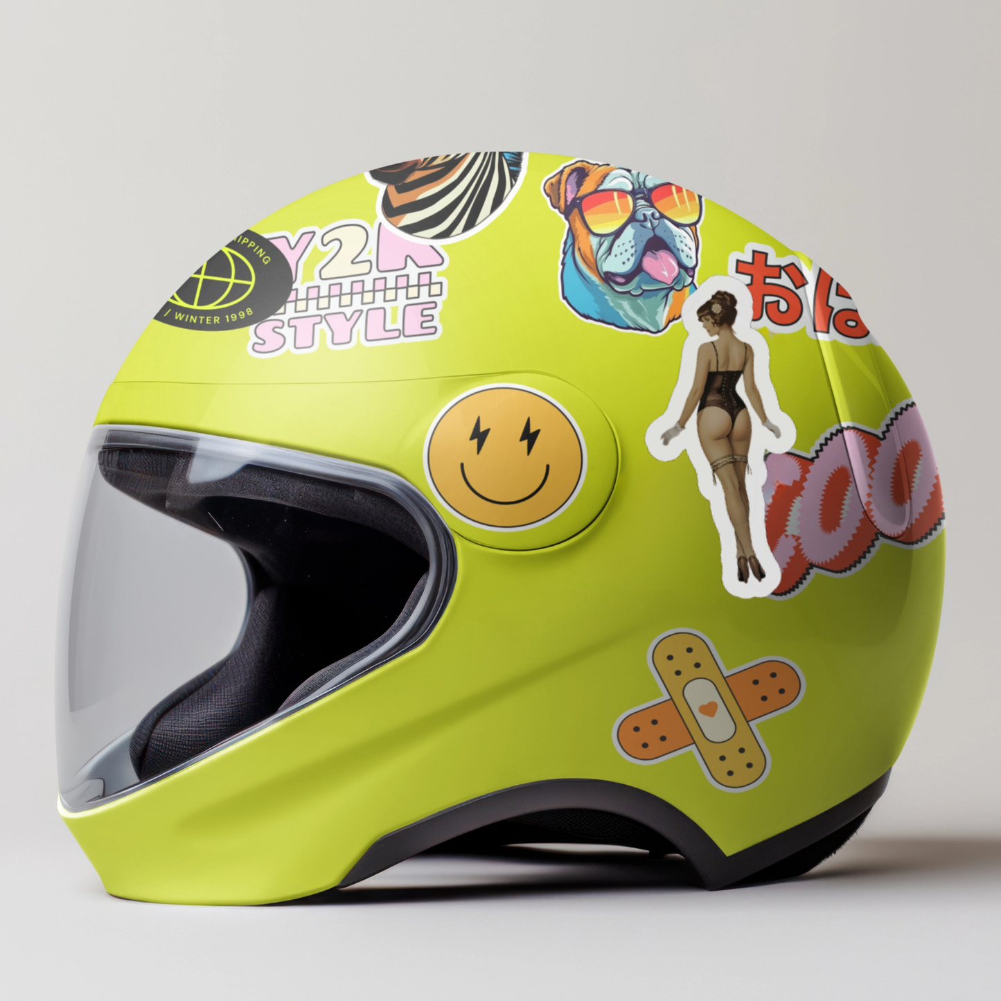 Yellow helmet with various stickers on a light gray background