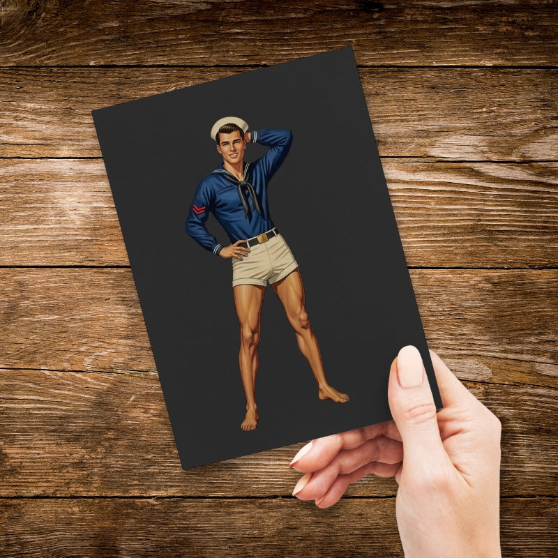 Hand holding a card with a vintage illustration of a man in uniform on a wooden surface