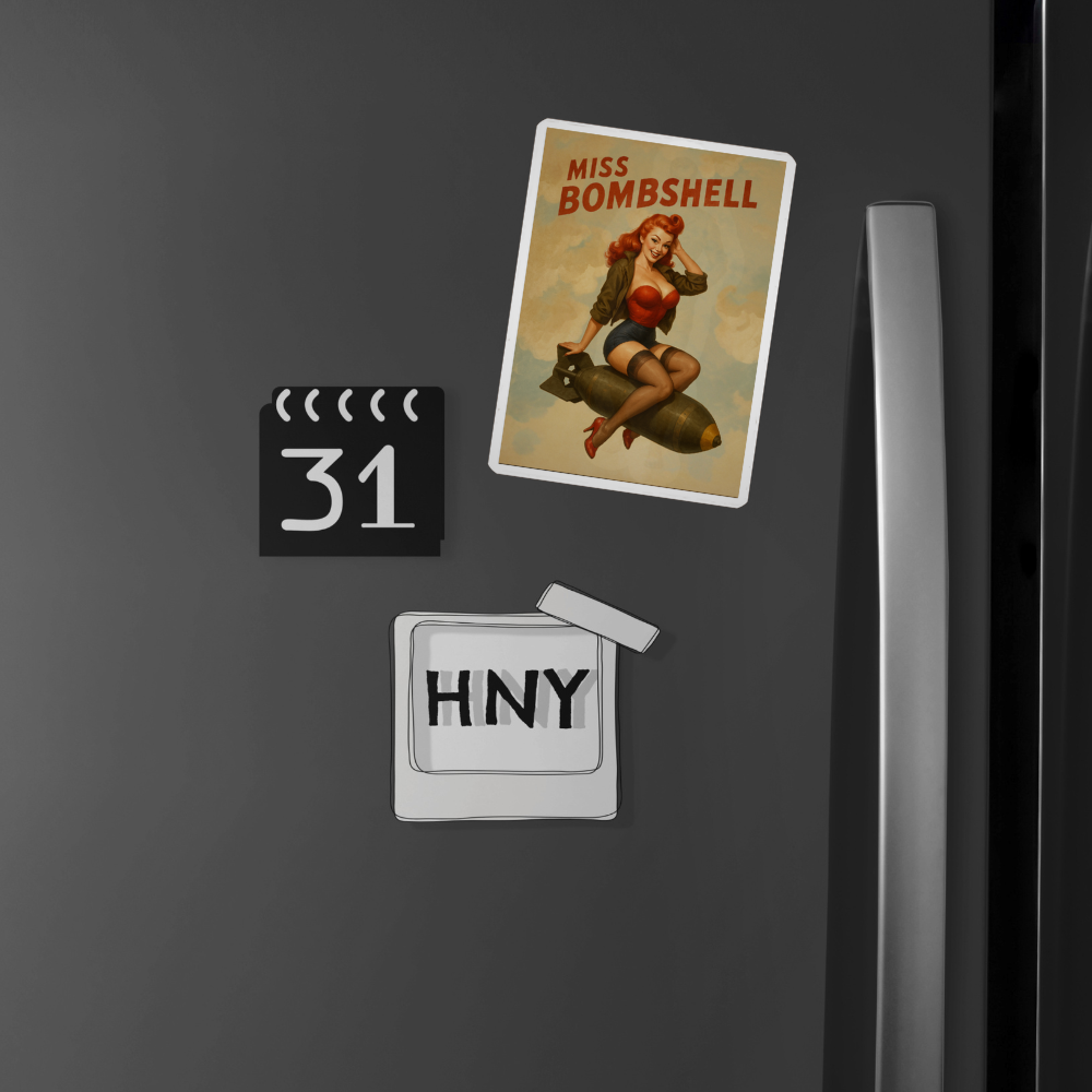 Fridge magnets including a 'Miss Bombshell' poster sticker, calendar, and 'HNY' sign on a dark surface.