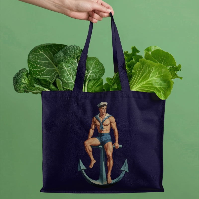 Navy tote bag with a sailor design holding groceries against a green background