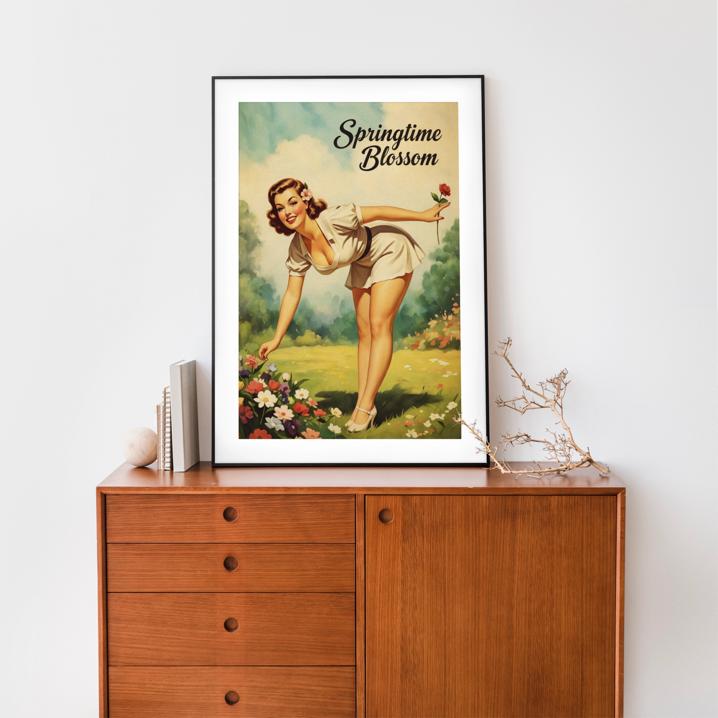 Framed vintage-style poster of a woman in a garden with 'Springtime Blossom' text on a wooden cabinet.