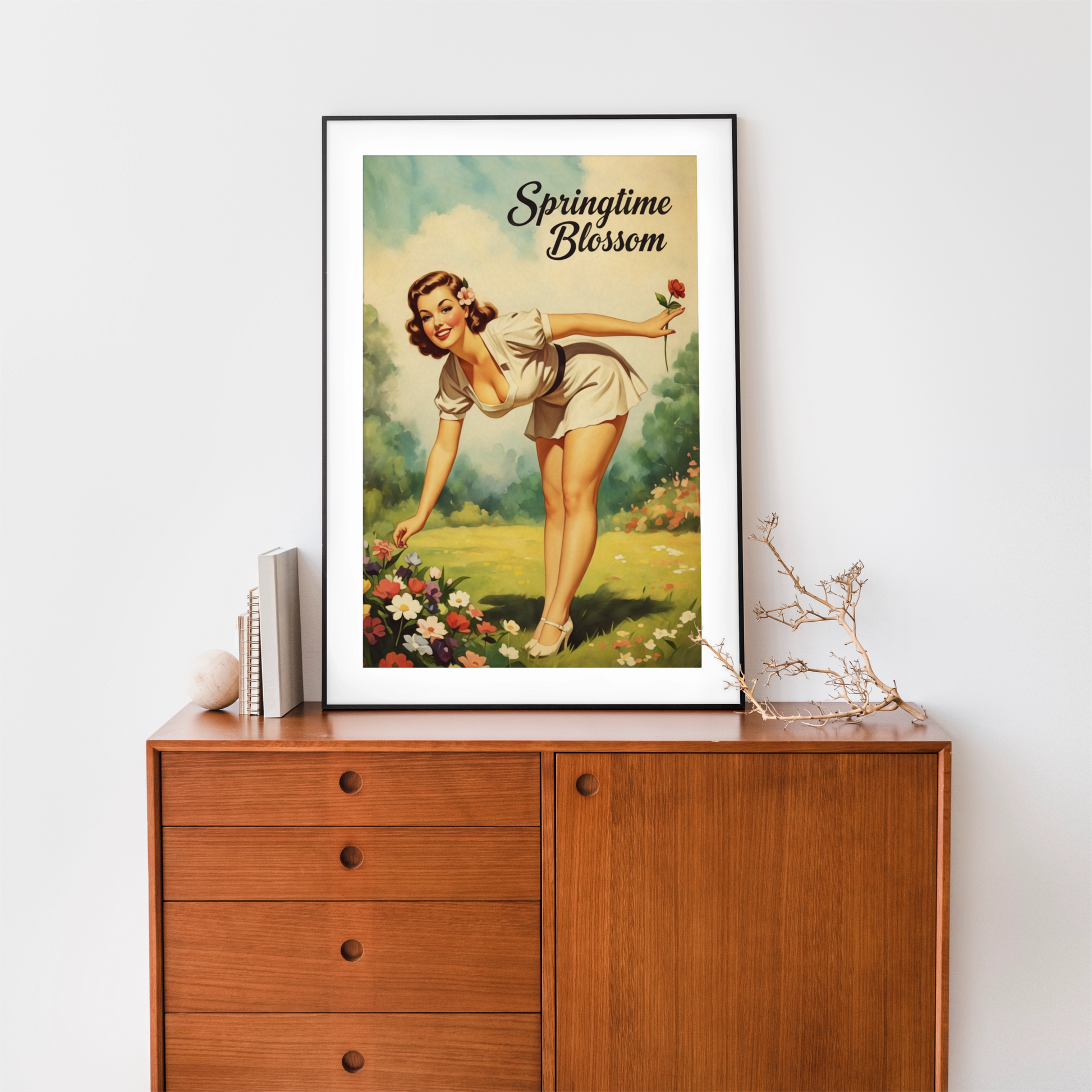 Framed vintage-style poster of a woman in a garden with 'Springtime Blossom' text on a wooden cabinet.