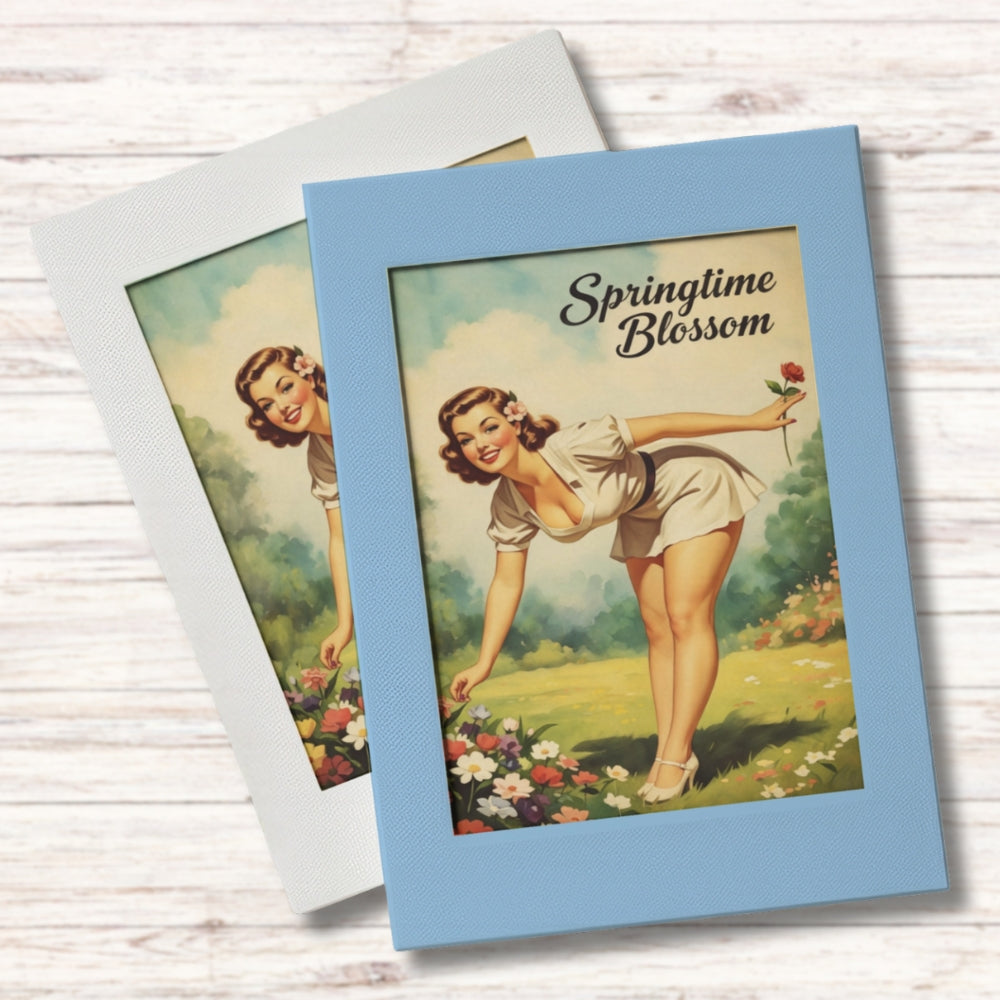Vintage-style greeting card with a woman in a field of flowers and 'Springtime Blossom' text.