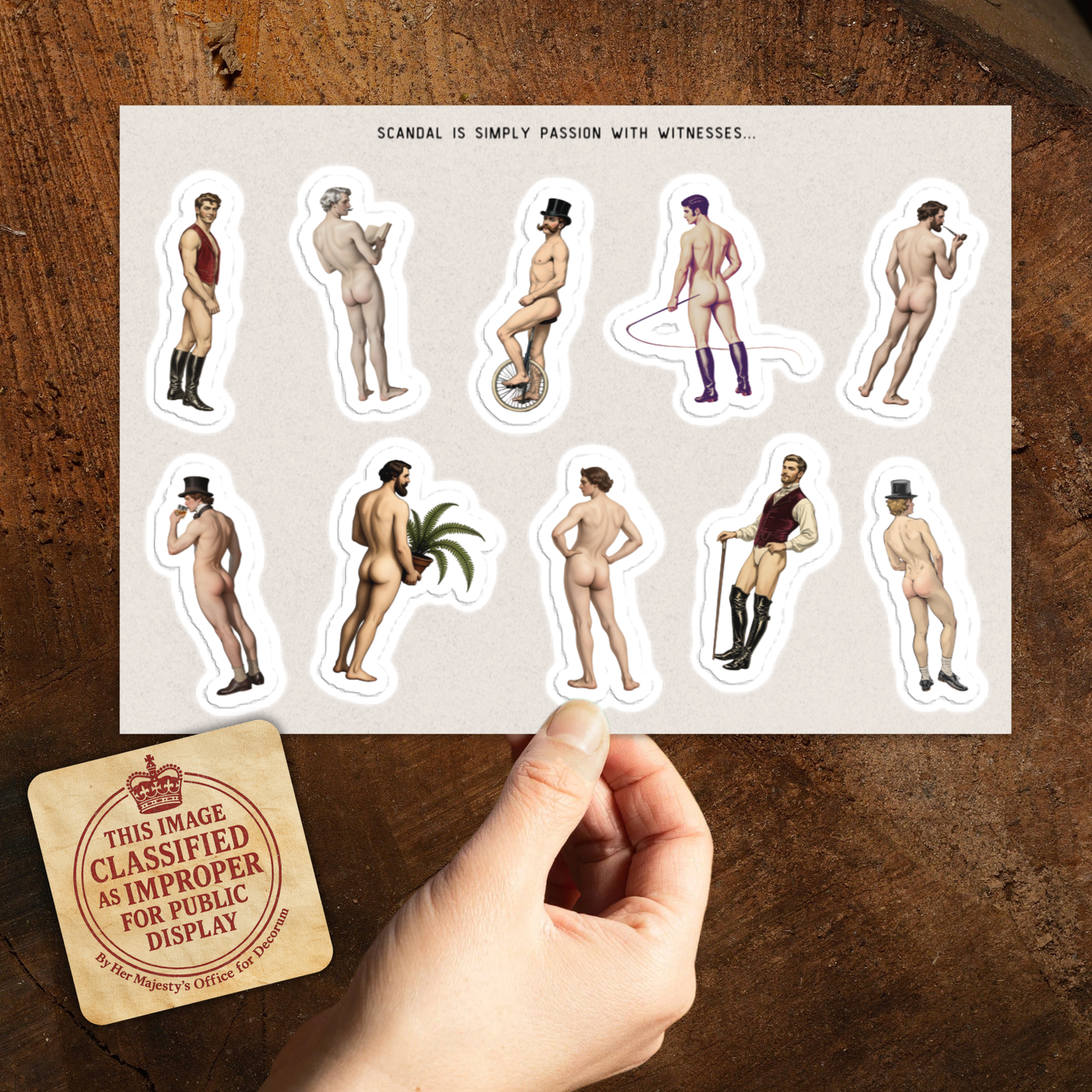 Sheet of stickers with nude figures on a wooden surface with a 'Mature Content' label.